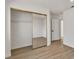 Bedroom with mirrored closet doors, hardwood floors, and fresh white paint, creating a serene atmosphere at 8416 Kawala Dr, Las Vegas, NV 89128