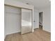 Bedroom featuring a closet with mirrored doors, hardwood floors, and fresh white paint throughout at 8416 Kawala Dr, Las Vegas, NV 89128