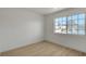 Bright bedroom with hardwood floors and a large window offering natural light and neighborhood views at 8416 Kawala Dr, Las Vegas, NV 89128