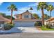 Charming two-story home with a three-car garage and lush landscaping, including mature palm trees at 8416 Kawala Dr, Las Vegas, NV 89128