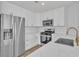 Modern kitchen featuring stainless steel appliances, white cabinets, and quartz countertops at 8416 Kawala Dr, Las Vegas, NV 89128