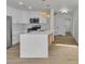 Well-lit kitchen boasts stainless steel appliances, white cabinetry and backsplash, with island at 8416 Kawala Dr, Las Vegas, NV 89128