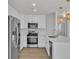 Well-lit kitchen boasts stainless steel appliances, white cabinetry and backsplash, with island at 8416 Kawala Dr, Las Vegas, NV 89128