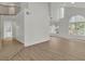 Spacious living room featuring wood-look floors, a large window, and an open layout at 8416 Kawala Dr, Las Vegas, NV 89128