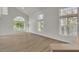Bright living room with multiple windows and wood-look flooring, offering an open and airy space at 8416 Kawala Dr, Las Vegas, NV 89128