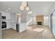Bright living room featuring hardwood floors, modern lighting, and a cozy fireplace at 8416 Kawala Dr, Las Vegas, NV 89128