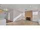 Spacious living room featuring a cozy fireplace, modern lighting, and neutral color palette at 8416 Kawala Dr, Las Vegas, NV 89128