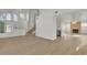 Spacious living area with fireplace, multiple windows, wood-look flooring and open staircase at 8416 Kawala Dr, Las Vegas, NV 89128
