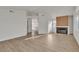 Bright living room with vinyl flooring, high ceilings, and a modern fireplace at 8416 Kawala Dr, Las Vegas, NV 89128