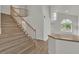 Open staircase with wood treads and white risers leading to an open-concept living area at 8416 Kawala Dr, Las Vegas, NV 89128