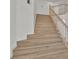 Staircase featuring light-colored hardwood steps and white risers, leading to the upper level of the home at 8416 Kawala Dr, Las Vegas, NV 89128