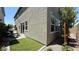 Cozy backyard features artificial turf, seating area with grill, and sliding door entrance to the home at 9136 Eagle Ford St, Las Vegas, NV 89113