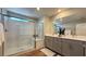 Contemporary bathroom with dual sinks, modern fixtures, and walk-in shower at 9136 Eagle Ford St, Las Vegas, NV 89113