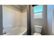 Bright bathroom featuring a toilet and bathtub with white tile, offering a clean aesthetic at 9136 Eagle Ford St, Las Vegas, NV 89113