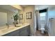 Bathroom featuring a dual sink vanity and a toilet next to a bath and shower combination at 9136 Eagle Ford St, Las Vegas, NV 89113