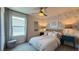 Stylish bedroom featuring floral wallpaper, a ceiling fan, and a cozy upholstered bed at 9136 Eagle Ford St, Las Vegas, NV 89113