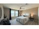 Well-lit bedroom with large windows, a ceiling fan, and a comfortable upholstered bed at 9136 Eagle Ford St, Las Vegas, NV 89113