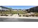 Well-maintained community park with green grass, seating areas, mature landscaping, and dog waste station at 9136 Eagle Ford St, Las Vegas, NV 89113