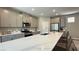 Modern kitchen with quartz countertops, stainless steel appliances, and a spacious island with seating at 9136 Eagle Ford St, Las Vegas, NV 89113
