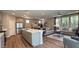 Bright, open-concept living space with luxury vinyl plank flooring connecting kitchen, dining, and living areas at 9136 Eagle Ford St, Las Vegas, NV 89113