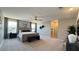 Spacious main bedroom with a ceiling fan, plush carpet, and ensuite bathroom at 9136 Eagle Ford St, Las Vegas, NV 89113