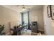 Bright home office space with large window, modern desk, and neutral decor offering comfortable workspace at 9136 Eagle Ford St, Las Vegas, NV 89113