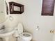 Bathroom with toilet and sink and dark wood accents at 9299 Adamshurst Ave, Las Vegas, NV 89148
