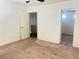 An interior bedroom featuring neutral carpet, ceiling fan, and access to ensuite bathroom at 9299 Adamshurst Ave, Las Vegas, NV 89148