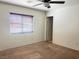 Bedroom with ceiling fan and large window bringing in natural light at 9299 Adamshurst Ave, Las Vegas, NV 89148