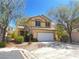 Inviting exterior with two-car garage, landscaped yard and sidewalk at 9299 Adamshurst Ave, Las Vegas, NV 89148
