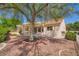 Spacious backyard featuring a covered patio, mature tree, and low-maintenance landscaping at 9717 Buckhorn Dr, Las Vegas, NV 89134