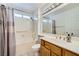 Bathroom with vanity, bathtub, shower, large mirror, and neutral decor at 9717 Buckhorn Dr, Las Vegas, NV 89134
