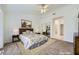 Bright, staged bedroom with neutral walls, decorative art, and mirrored closet doors at 9717 Buckhorn Dr, Las Vegas, NV 89134