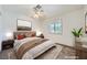Staged bedroom with neutral walls, plush bed, side tables, and bright natural light from windows at 9717 Buckhorn Dr, Las Vegas, NV 89134
