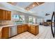 Bright kitchen with oak cabinets, tile flooring, white countertops, and stainless steel appliances at 9717 Buckhorn Dr, Las Vegas, NV 89134