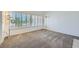 Empty living room with a large window featuring plantation shutters, and carpet flooring at 9717 Buckhorn Dr, Las Vegas, NV 89134