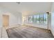 Empty living room features tile flooring, plantation shutters, and a gold colored floor lamp at 9717 Buckhorn Dr, Las Vegas, NV 89134
