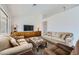 Spacious living room featuring neutral tones, comfortable seating, and a large screen television at 9717 Buckhorn Dr, Las Vegas, NV 89134
