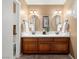 Bathroom with double sinks and matching framed mirrors at 2821 Whispering Wind Dr, Las Vegas, NV 89117