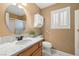 Well-lit bathroom with marble countertop, toilet, and shuttered window, providing a clean and functional space at 2821 Whispering Wind Dr, Las Vegas, NV 89117