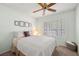 Cozy bedroom features a ceiling fan, shuttered windows, and a comfortable bed for a relaxing retreat at 2821 Whispering Wind Dr, Las Vegas, NV 89117