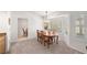 Cozy dining area filled with natural light, lovely light fixture, and a seamless flow to the kitchen at 2821 Whispering Wind Dr, Las Vegas, NV 89117