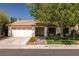 Single-story home featuring a red tile roof, mature landscaping, and a welcoming entrance at 2821 Whispering Wind Dr, Las Vegas, NV 89117