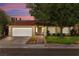 Charming single-story home featuring a red tile roof, well-manicured lawn, and inviting curb appeal at 2821 Whispering Wind Dr, Las Vegas, NV 89117