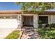 Inviting single-story home with well-kept landscaping, a tile roof, and a charming walkway to the front door at 2821 Whispering Wind Dr, Las Vegas, NV 89117
