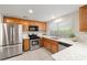 Bright kitchen featuring wood cabinets and stainless steel appliances at 2821 Whispering Wind Dr, Las Vegas, NV 89117