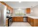 Well-lit kitchen with stainless steel appliances and wood cabinetry at 2821 Whispering Wind Dr, Las Vegas, NV 89117