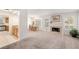 Comfortable living area with a fireplace, lots of light, and open to the dining room and kitchen at 2821 Whispering Wind Dr, Las Vegas, NV 89117