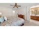 Bedroom with neutral paint, ceiling fan, leading to bathroom and closet at 2821 Whispering Wind Dr, Las Vegas, NV 89117