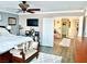 Bedroom doorway with a king-size bed, side tables, ceiling fan, and light gray accent walls with wooden floors at , Las Vegas, NV 89141